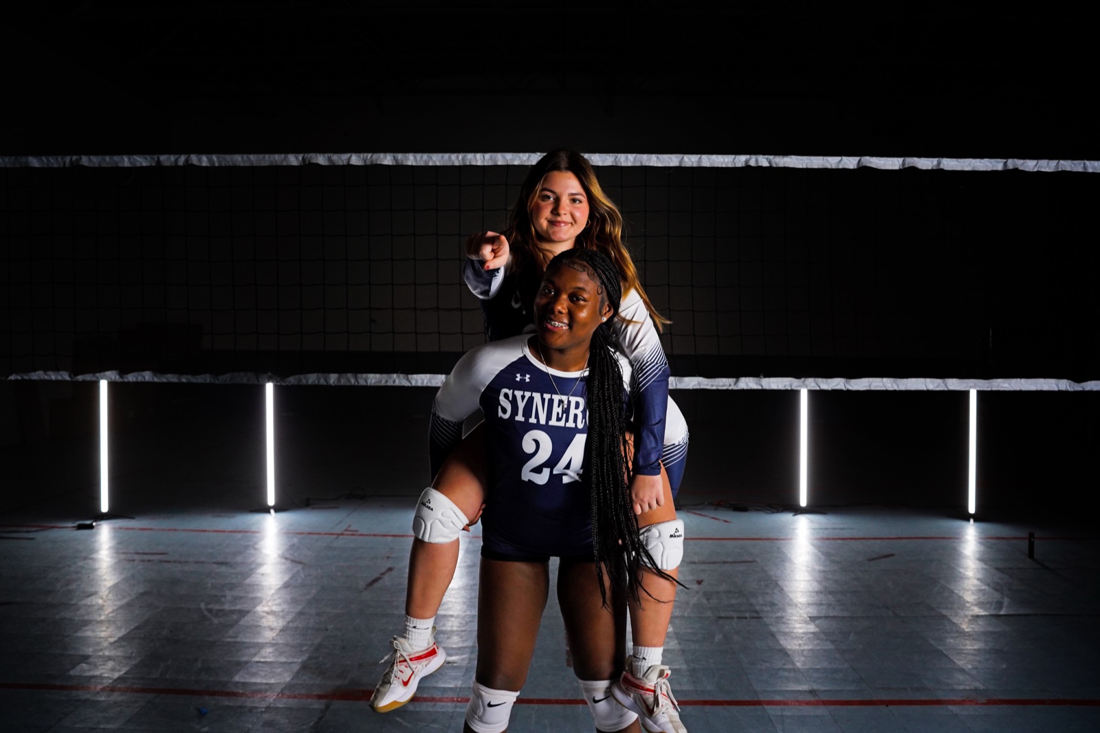 Two athletes photographed together at a media day