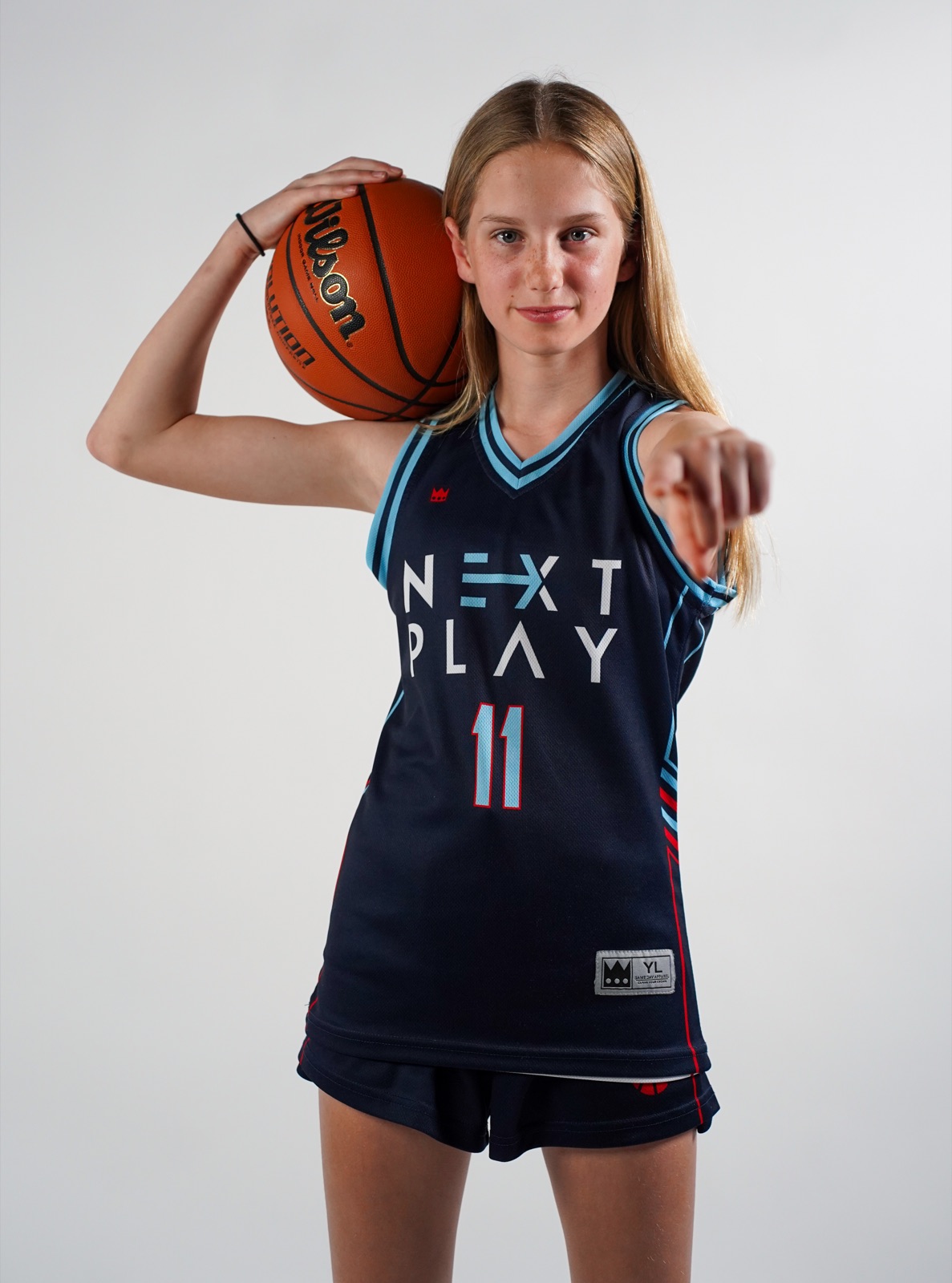 Classic professional portrait of a high school athlete in uniform on a clean studio background